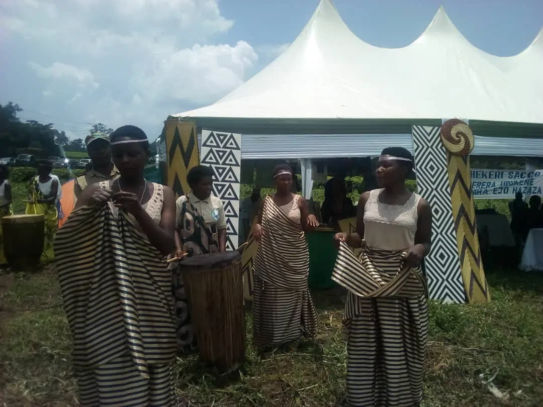 
              Rwandan Women dancing outside wearing traditional clothing